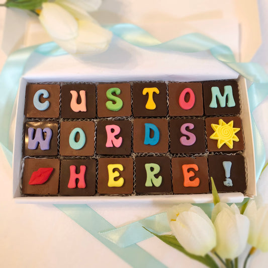 18 Solid square chocolates with one fondant letter or symbol on each, spell out anything you would like.