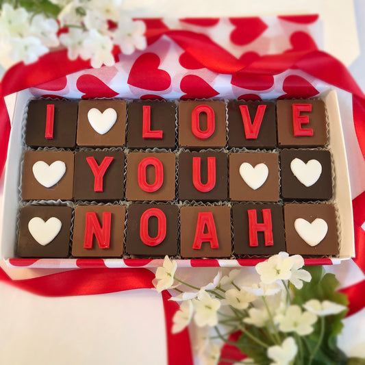 Solid square chocolates with one fondant letter or heart on each, spell out - I Love You... and the persons name.