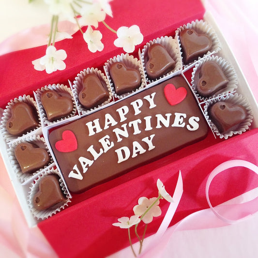 Solid chocolate bar with lettering that reads Happy Valentines Day, surrounded by 10 solid chocolate hearts.